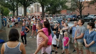 More than 100 people crowd together to watch Chimney Swifts form a "swiftnado" before entering the chimney of the Birmingham Housing Authority. 