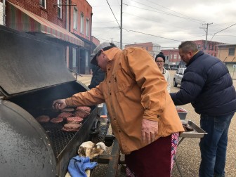 Clay Cleghorn grills burgers outside the Coosa Cleaver restaurant for first responders and residents in need. 