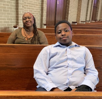 Deon Arnold and his grandmother at Sixth Avenue Baptist Church.