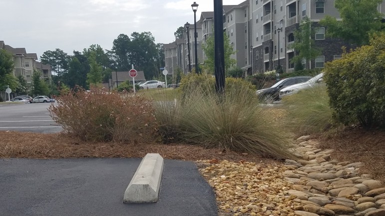 The Crowne at Cahaba River Apartments utilize low-impact development techniques, like bioswales with gravel that help increase filtration of water. 