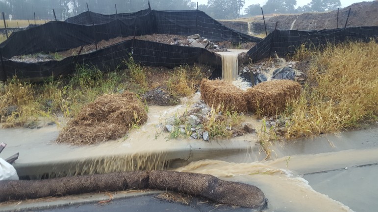 Sediment barriers fail to control rainwater on a construction site.