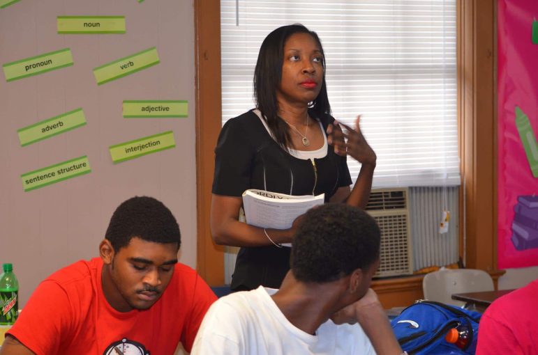 Donna Dukes works with students on vocabulary words at Maranathan Academy in Birmingham. She started the school in 1991.