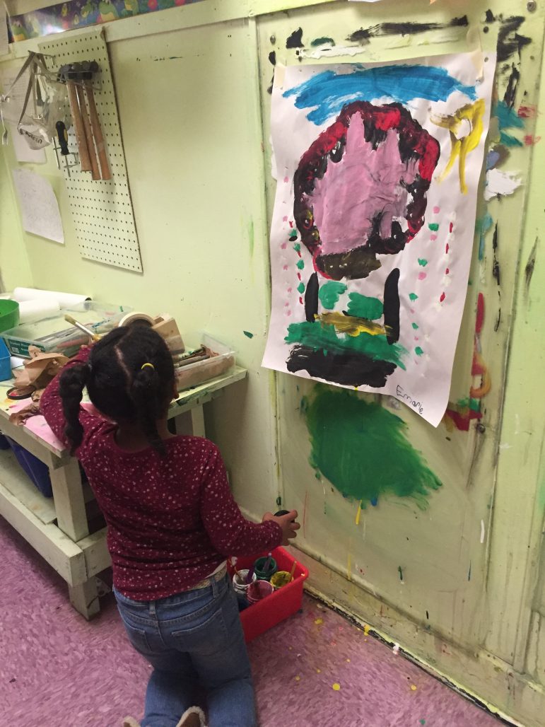 Kindergartner Emarie puts paint supplies away at Central Park School For Children in Durham, North Carolina. The charter school promotes a hands-on, project-based curriculum.