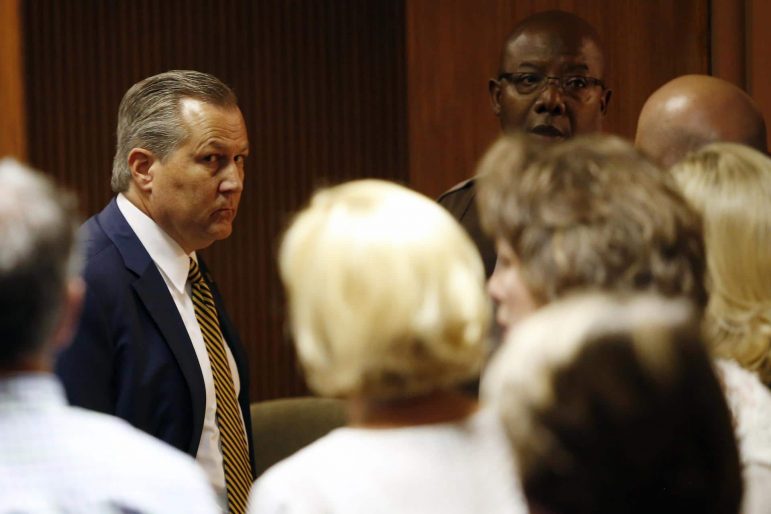 Mike Hubbard looks at family and friends sitting in the courtroom as deputies wait to take Hubbard into custody on Friday, June 10, 2016, in Opelika, Ala.