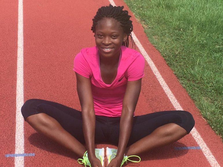 Jayla Kirkland of Woodlawn High School warms up on the track at Hayes K-8 School before starting her training session.