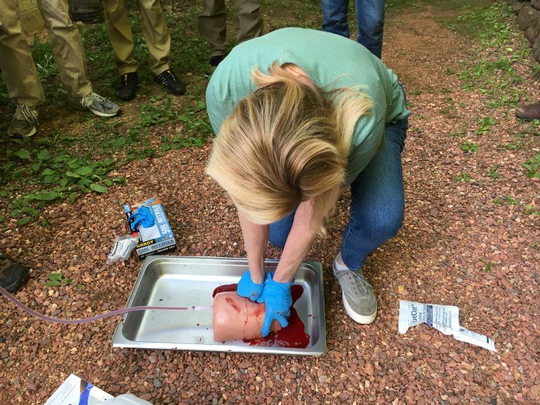 Anne Balch packs a simulated gunshot wound with clot-inducing gauze behind the Ruffner Mountain Nature Center.