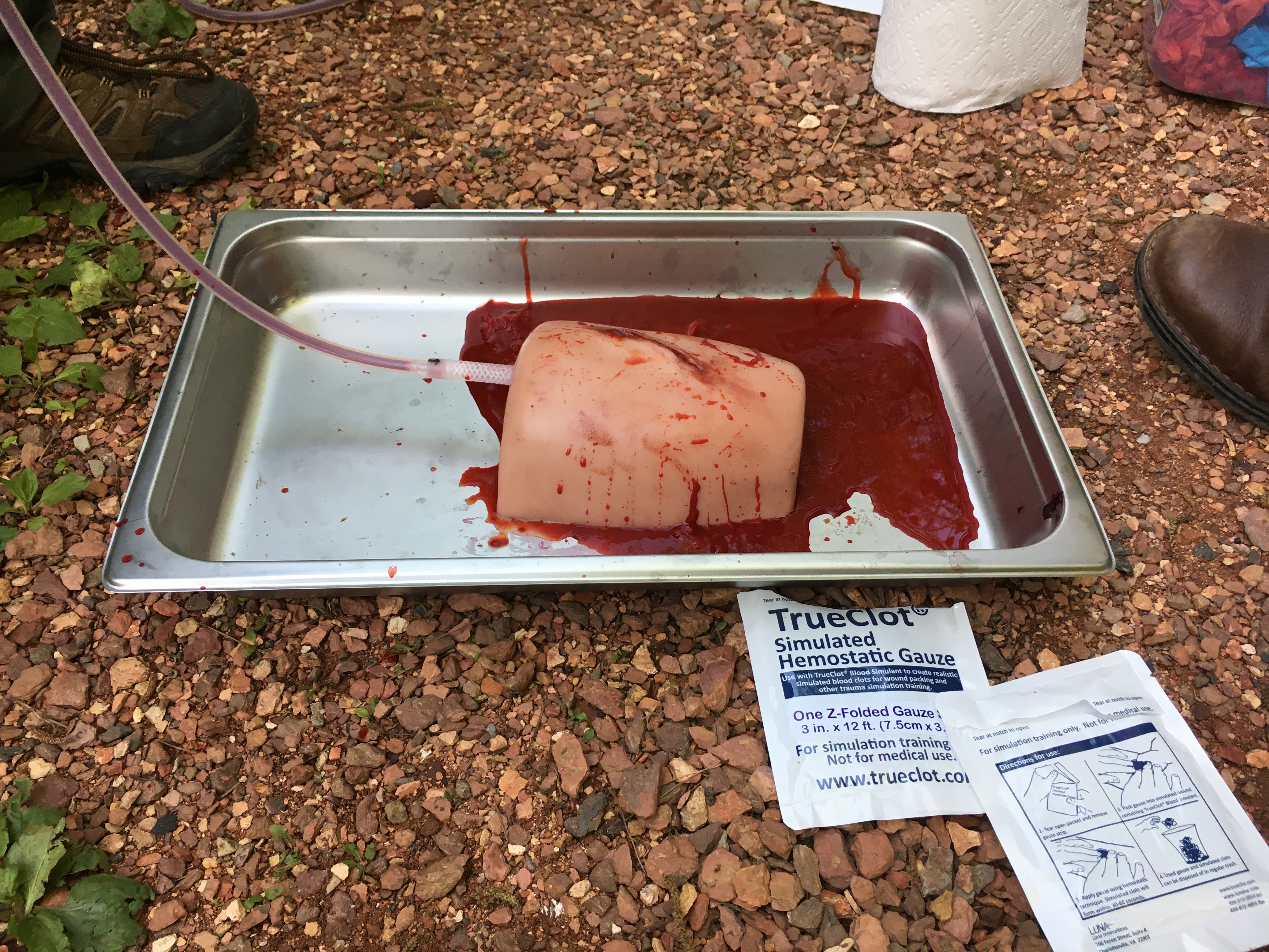 Tools of the training trade: hemostatic gauze, fake blood that clots like the real thing, and a fake human thigh.