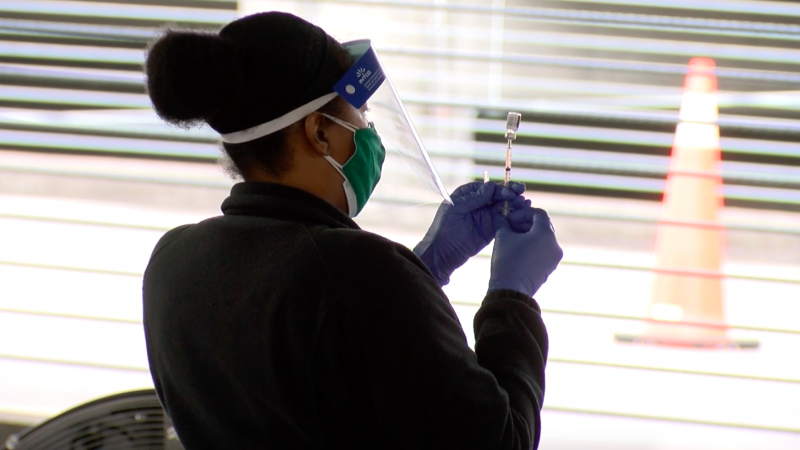 A medical worker prepares a vaccine at the UAB Highlands Hospital COVID-19 vaccination site.