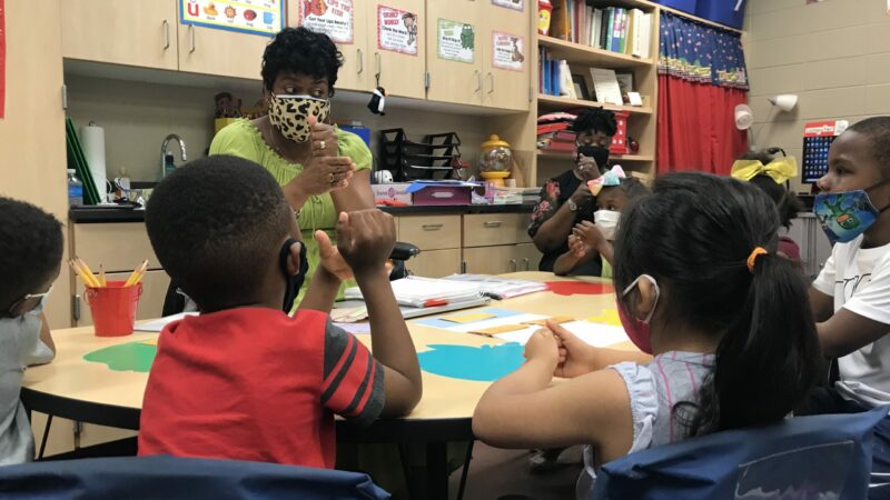 Kimberly Isaac, who is a teacher at West End Academy, guides students in phonics practice at a summer literacy camp.