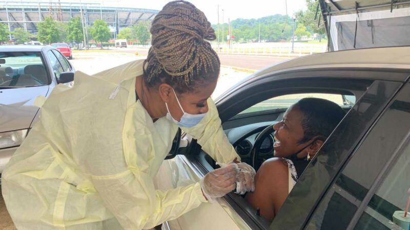 Alexandria Hilliard is the alternate vaccination coordinator at the Legion Field COVID-19 vaccination. She administered a dose of the vaccine to Sandy.