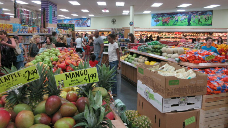 In this file photo, a group of people shop in the produce section of a Trader Joe’s grocery store in Metairie, Louisiana.