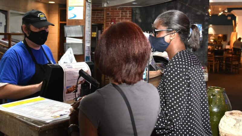 Jonathan Foster takes a pair of orders at the Fish Market on Southside.