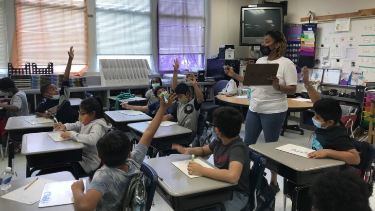 Ashley Hogan guides her fourth grade class through a math lesson at Glen Iris Elementary School during fall intersession.