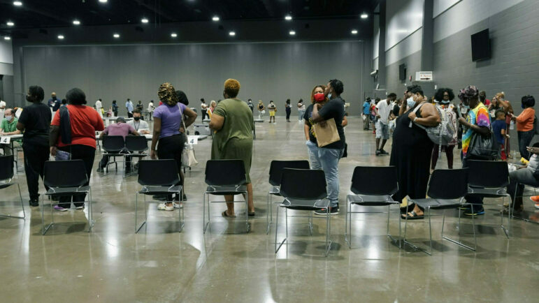 People in Jackson, Mississippi stand in line waiting to apply for rental assistance.