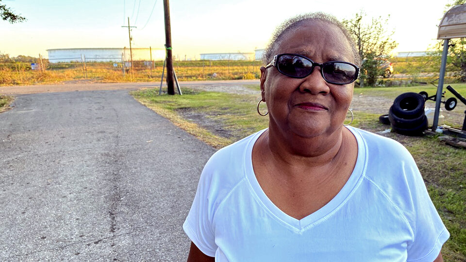 Brenda Bryant stands outside her home in St. James Parish.
