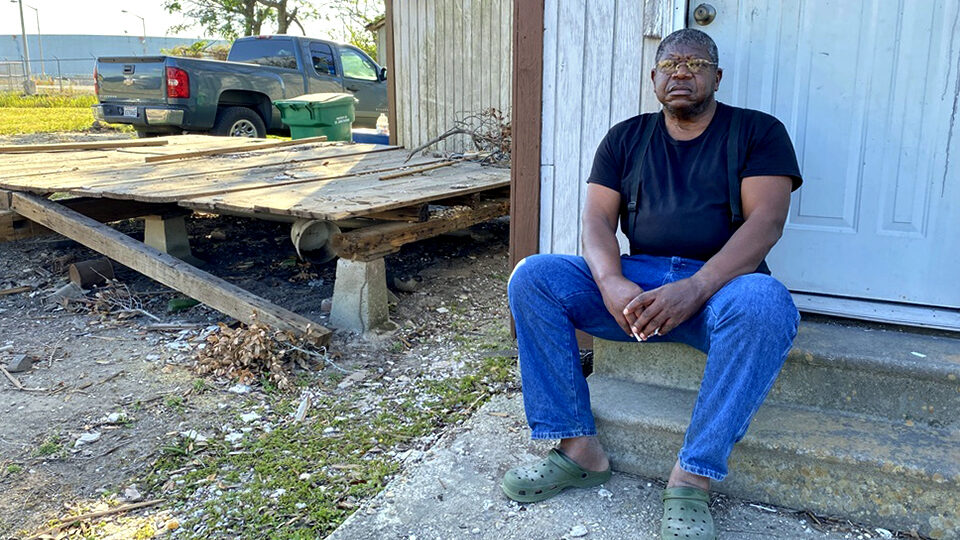 Michael Coleman sits in front of his home in Reserve, La. The house is the only one still standing on a residential street that sits next to the Marathon Petroleum refinery.