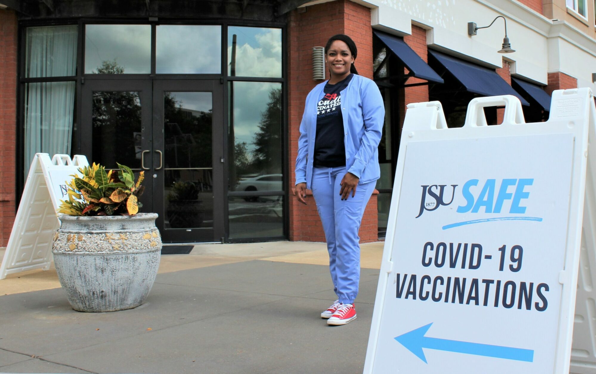 Michelle Owens Michelle Owens with the Jackson-Hinds Comprehensive Health Center stands in front of a COVID-19 vaccination clinic at Jackson State University