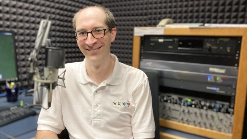 Andrew Yeager before a mic in the recording studio.