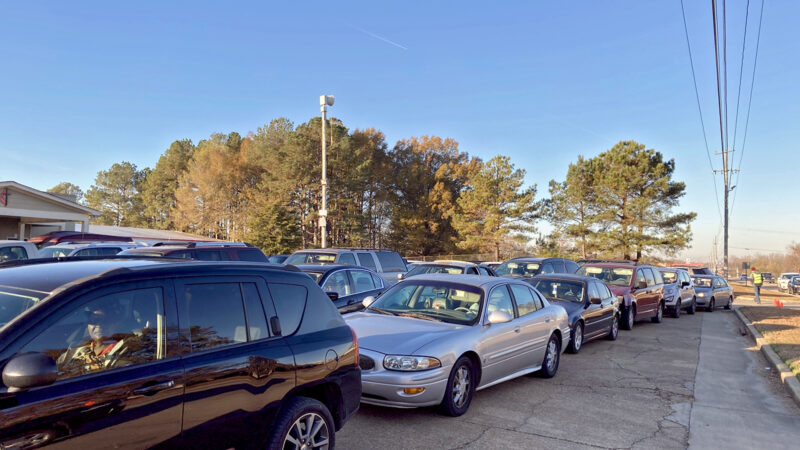 Mississippi residents wait in line in their cars to receive food and supplies at the Saint Luke’s Food Pantry in Tupelo, Dec. 2, 2021.