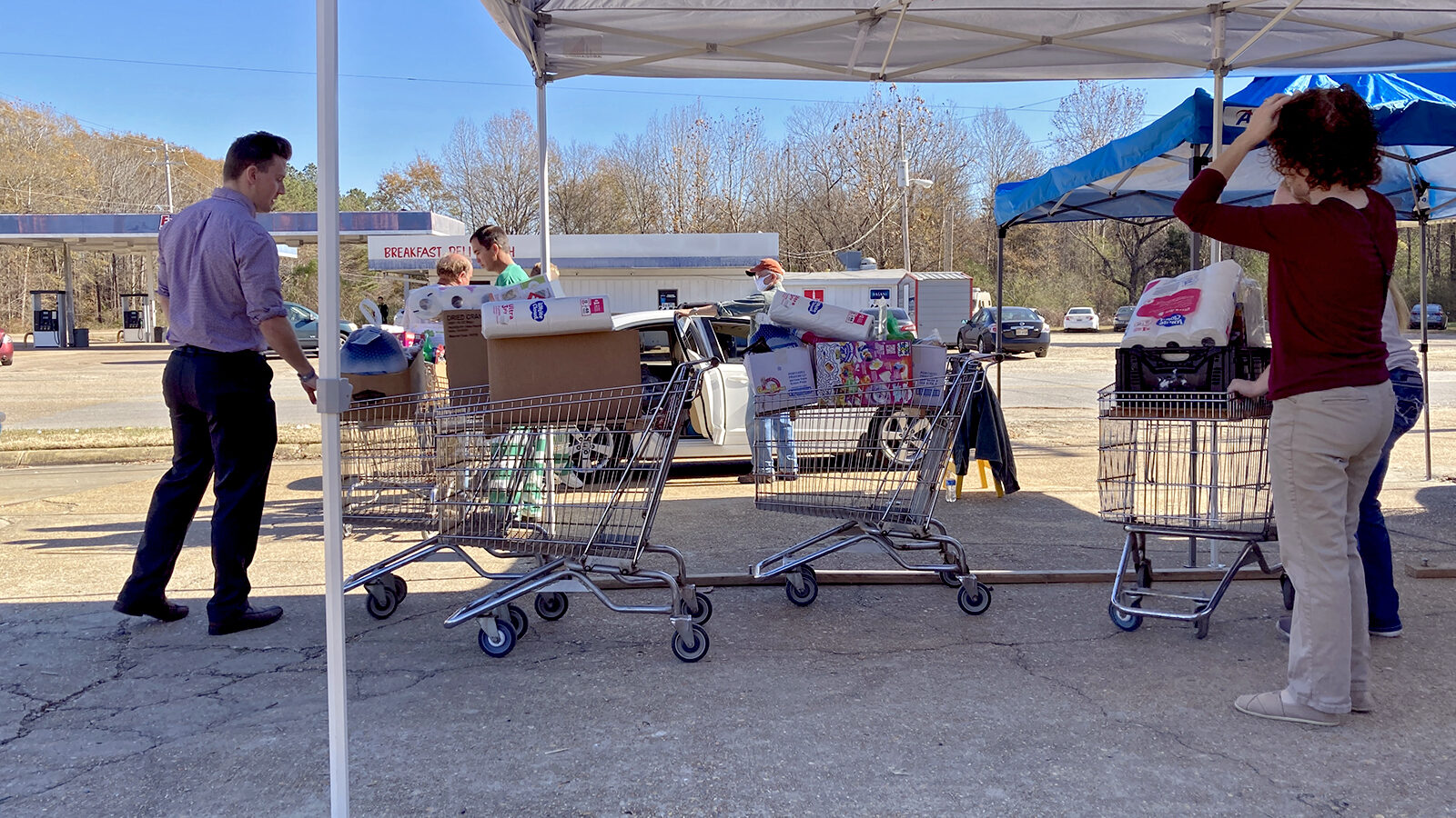 Two volunteers at Saint Luke’s Food Pantry in Tupelo, Mississippi prepare shopping carts full of food and supplies to donate to families in need on Thursday, Dec. 2, 2021.