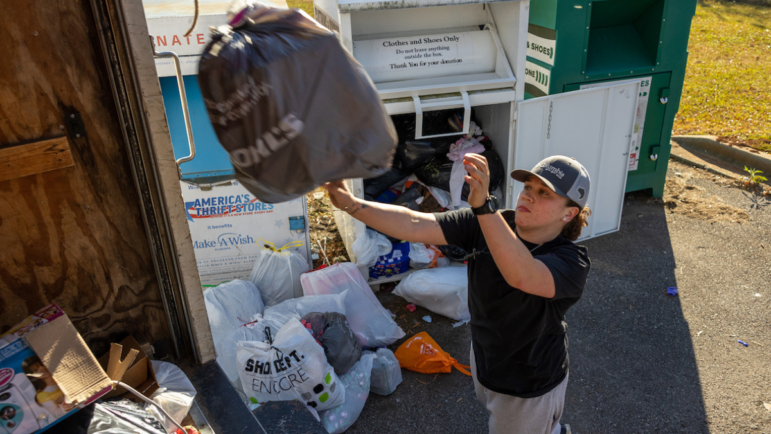 Tiara Helm loads donations into a truck as part of her job at a thrift store in Anniston, Ala.