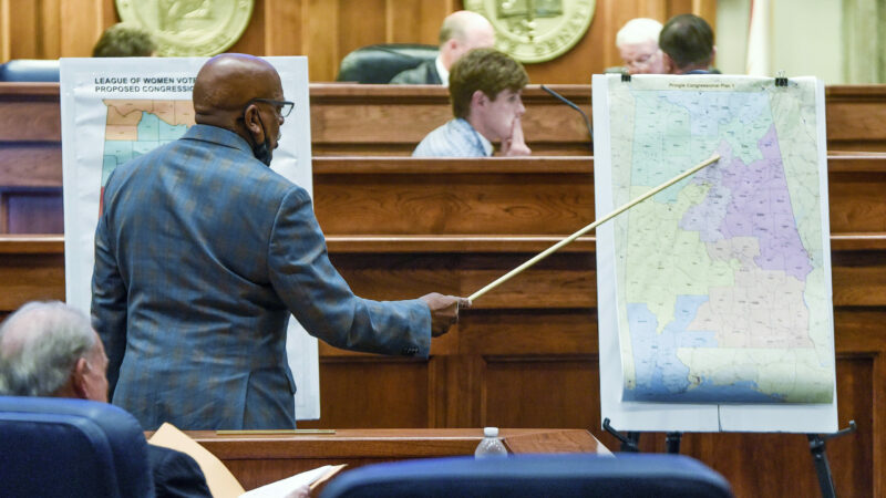 FILE - Sen. Rodger Smitherman compares U.S. Representative district maps during a special session on redistricting at the Alabama Statehouse in Montgomery, Ala., Nov. 3, 2021. Federal judges have blocked Alabama from using newly drawn congressional districts in upcoming elections. A three-judge panel issued a preliminary injunction Monday, Jan. 24, 2022. (Mickey Welsh/The Montgomery Advertiser via AP, File)