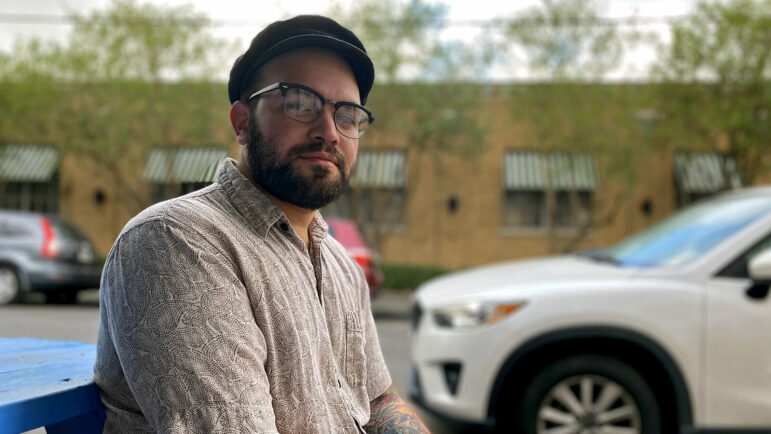 Matthew Seltzer, a documentary photographer, sits on a bench in New Orleans, Louisiana.