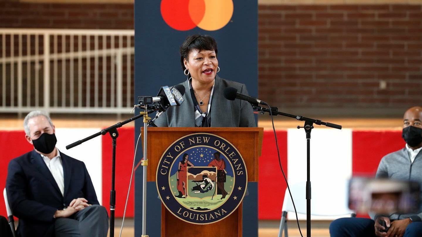 New Orleans Mayor LaToya Cantrell stands at a podium and announces the city's partnership to launch the Crescent City Card Program on Nov. 11, 2021.