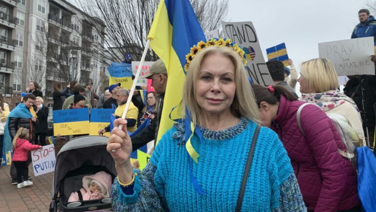 Photo of Nataliya Russo holding a Ukrainian flag