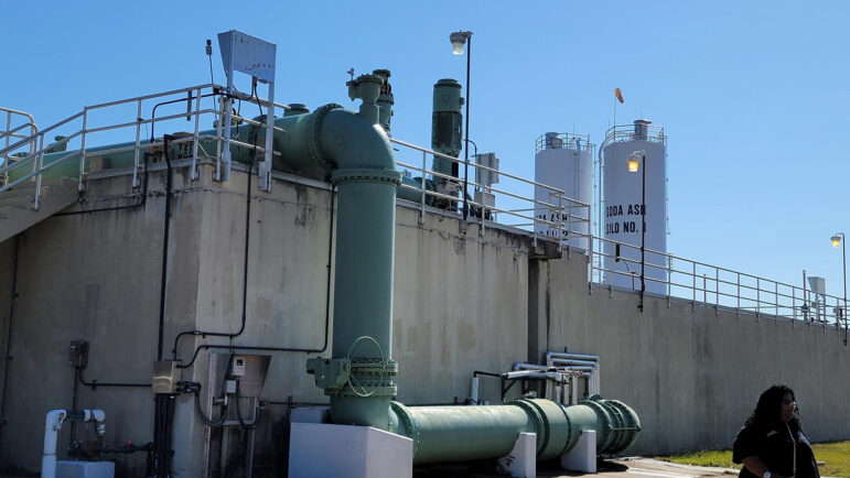 A woman stands outside he O.B. Curtis Water Treatment Plant in Jackson, Mississippi.