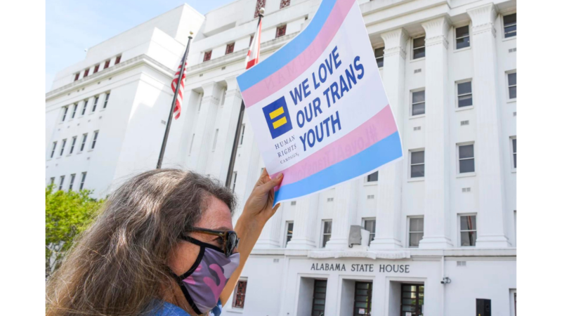 Jodi Womack holds a sign that reads "We Love Our Trans Youth" during a rally at the Alabama State House to draw attention to anti-transgender legislation introduced in Alabama on March 30, 2021 in Montgomery, Ala.