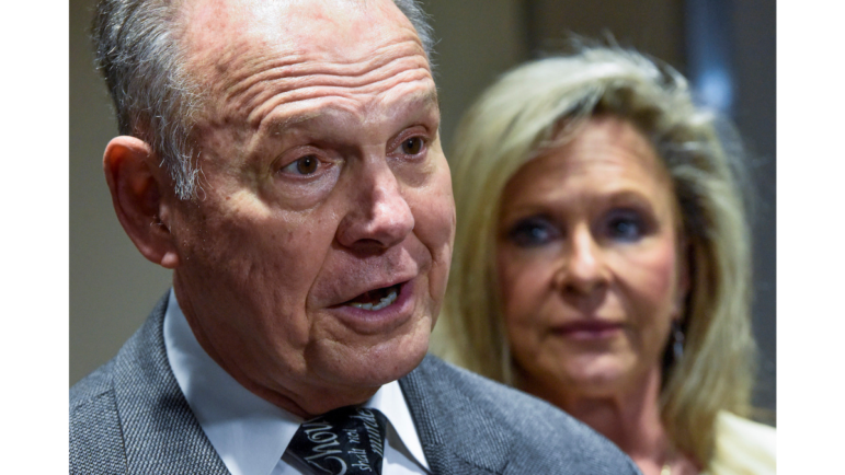 Roy Moore, left, and his wife Kayla Moore, right, pause to comment as they leave the courtroom at the Montgomery County Courthouse in Montgomery, Ala., on Wednesday, Feb. 2, 2022. A jury has found that no defamation occurred in dueling lawsuits between Moore and Leigh Corfman, the woman who accused him of molesting her when she was 14. Corfman came forward during the 2017 Senate race and said Moore sexually touched her in 1979 when he was an assistant district attorney in his 30s.
