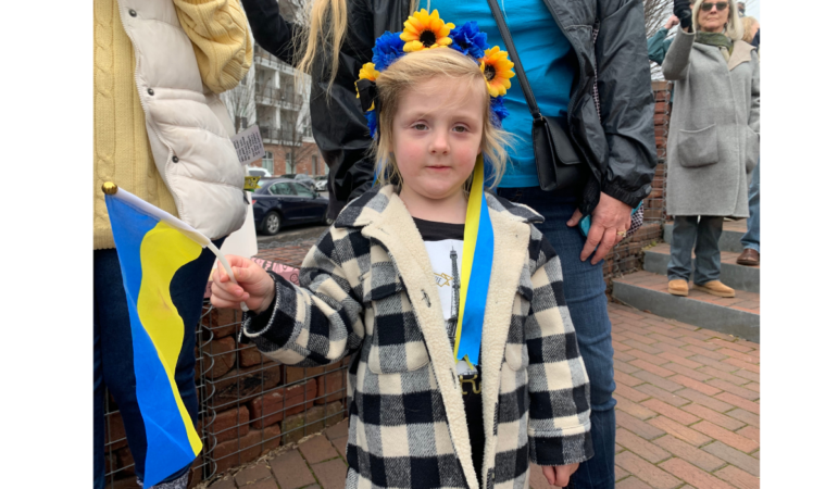Little girl holding a Ukrainian flag at the rally in Birmingham