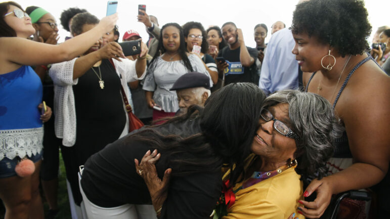 utherine Lucy Foster, the first black student admitted to an all-white college in Alabama, gets a hug from University of Alabama senior Alecea Watkins, as The University of Alabama unveiled a historic marker honoring Friday, Sept. 15, 2017, in Tuscaloosa, Ala. The University of Alabama is reconsidering its decision last week to retain the name of a one-time governor who led the Ku Klux Klan on a campus building while adding the name of the school's first Black student. Trustees will meet publicly in a livestreamed video conference on Friday, Feb. 11, 202, to revisit their decision to keep the name of former Alabama Gov. Bibb Graves on a three-story hall while renaming it Lucy-Graves Hall to also honor Autherine Lucy Foster, the University of Alabama System said. (Gary Cosby Jr./The Tuscaloosa News via AP)