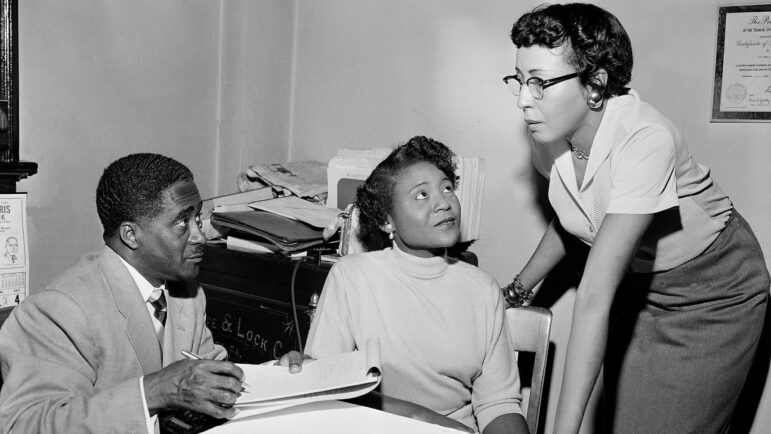 FILE - This file photo shows Autherine Lucy Foster, center, the first Black person to attend University of Alabama, discussing her return to campus following mob demonstrations in Birmingham, Ala., on Feb. 7, 1956. Angela Foster Dickerson, Foster's daughter, says her mother died Wednesday, March 2, 2022 and said a family statement would be released.