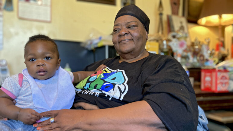 Rosemarie Edwards poses for a photo while babysitting her great-granddaughter at her home in Boligee, Alabama.