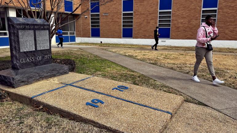 A student at Jackson State University walks by the Martyrs of May 14, 1970 memorial near Alexander Hall.