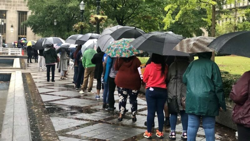 Hundreds of voters stood in line in the rain at the Jefferson County Courthouse to cast absentee ballots in person before the November election. Federal funds helped repay election officials for extra steps they had to take during the unusual year.