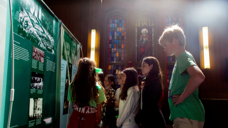 Holy Name of Jesus School students listen to a tour guide as they walk through a traveling exhibition titled "Anne Frank- a history for today" on Thursday, March 17, 2022, at Loyola University of New Orleans.