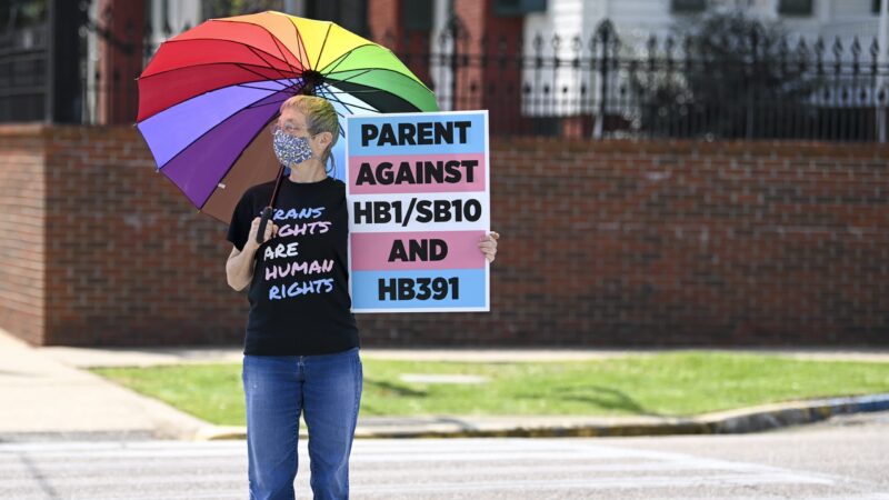 A Protestor holds a sign at a rally in Montgomery, Alabama on March 30, 2021 to draw attention to anti-transgender legislation.