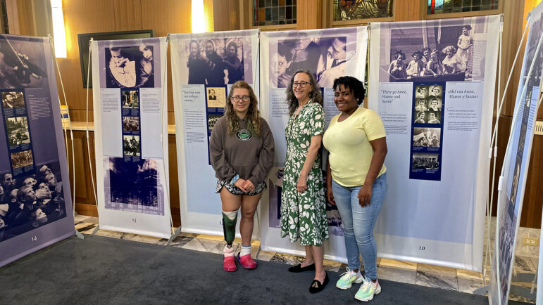 University students and Anne Frank exhibit guides Kaley Delker (left) and Diamond Dixon (right) meet with professor Naomi Yavne-Klos (center).