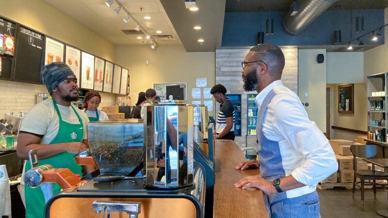 Birmingham Mayor Randall Woodfin, right, orders a coffee at Starbucks location downtown on May 11, 2022.