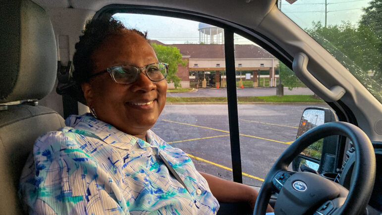 Lorrie Bowen sits in the driver seat of a vanpool traveling to the Biloxi VA Medical Center in Mississippi.