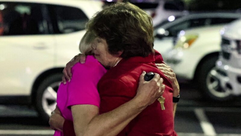 Two members of Saint Stevens Episcopal Church hug after a shooting at the church killed two and injured one.