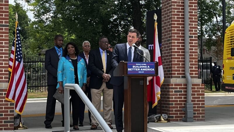 Secretary of Transportation Pete Buttigieg addresses a crowd in Birmingham's Woodlawn neighborhood to announce a new transportation initiative.