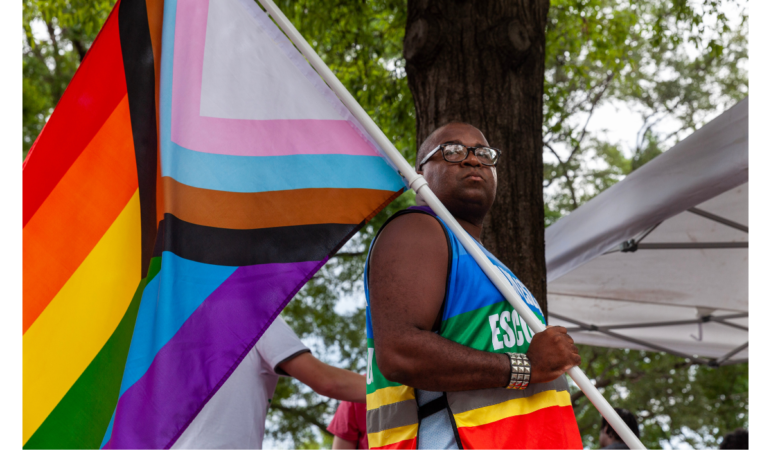 Travis Jackson, a volunteer with POWER (People Organizing for Women's Empowerment & Rights) House, watches a crowd during a rally protesting the Supreme Court's ruling that overturned Roe v. Wade on Saturday, June 25, 2022, in Birmingham, Alabama. That ruling effectively ended legal abortion in Alabama with few exceptions. (Photo by Rashah McChesney/Gulf States Newsroom - WBHM)