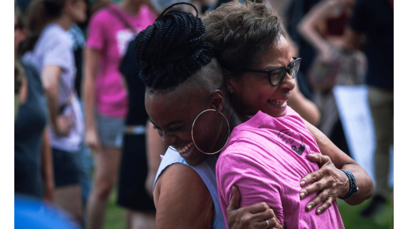 Marcia Forrest hugs Nina Morgan during a rally protesting the Supreme Court's decision to overturn Roe v. Wade on Saturday, June 25, 2022, in Birmingham, Alabama. Forrest and Moore know each other from PANIC –People Against Neighborhood Industrial Contamination – meetings in Alabama.