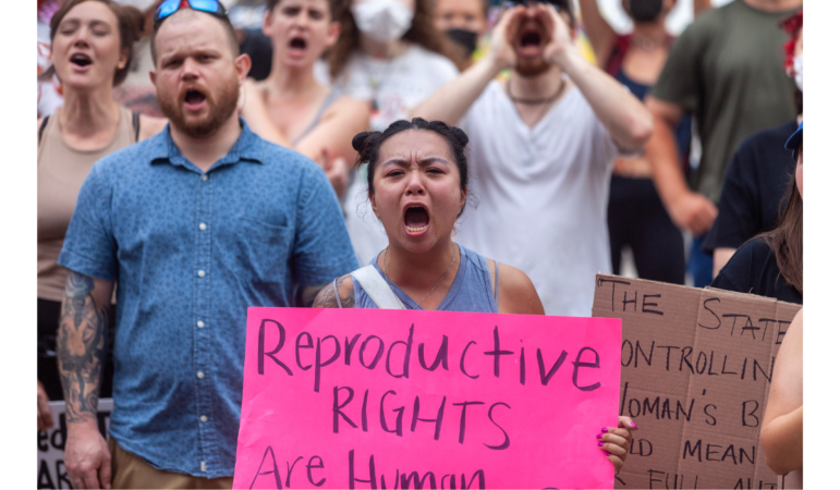 Dung Kieu Nguyen chants with the crowd during a protest against the Supreme Court's ruling overturning Roe v. Wade on Saturday, June 25, 2022, in Birmingham. Several hundred people massed in Linn Park for a rally organized by the Yellowhammer Fund which provides financial assistance for people seeking abortion care. (Photo by Rashah McChesney/Gulf States Newsroom - WBHM)