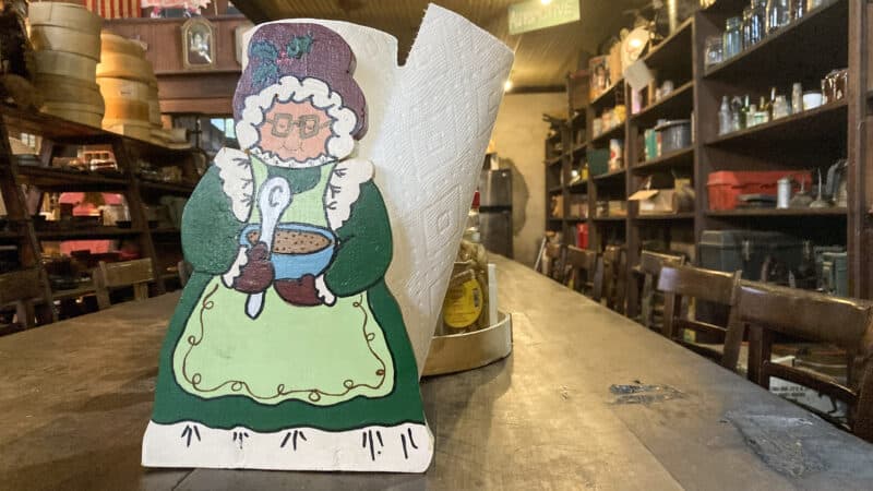 A paper towel holder in the shape of a grandmother sits in the Simmons-Wright Company country store in Kewanee, Mississippi, July 1, 2022.