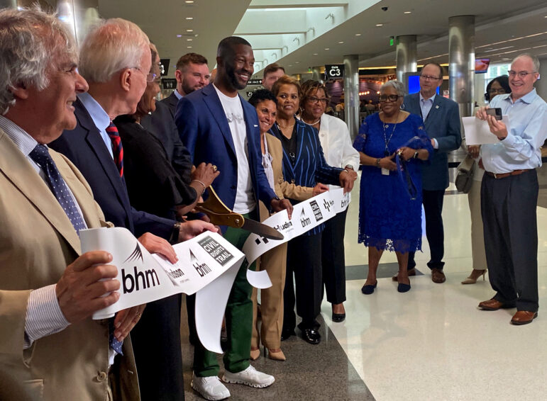 Birmingham Mayor Randall Woodfin (center) participates in a ribbon-cutting for the U.S. Civil Rights Trail Market and mural with other city leaders at Birmingham-Shuttlesworth International Airport.